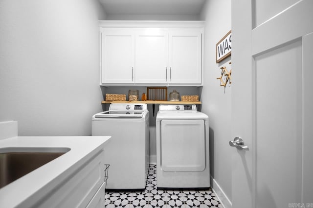 laundry area with light tile patterned floors, cabinets, and independent washer and dryer