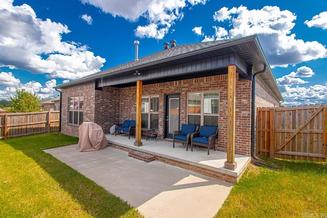 rear view of house featuring a patio and a yard