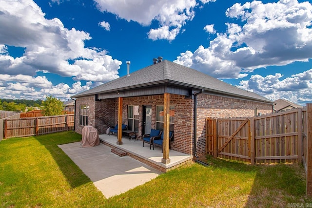 back of property with a lawn and a patio area