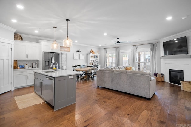 kitchen featuring a center island with sink, white cabinetry, and dark hardwood / wood-style flooring