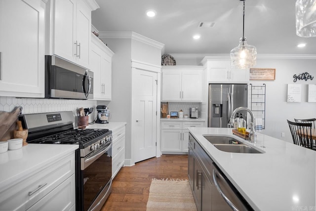 kitchen featuring white cabinets, appliances with stainless steel finishes, and sink