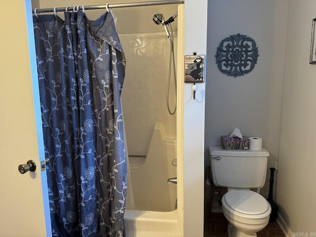 bathroom with shower / bath combo and toilet