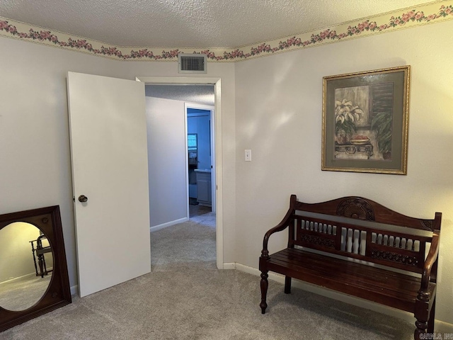 carpeted bedroom with a textured ceiling