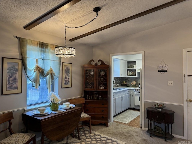 dining space with light colored carpet, a textured ceiling, and lofted ceiling