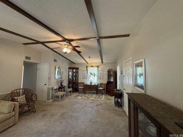 carpeted living room with ceiling fan, a textured ceiling, and plenty of natural light