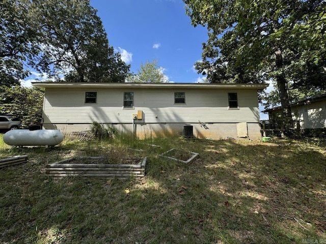 rear view of house featuring central AC unit