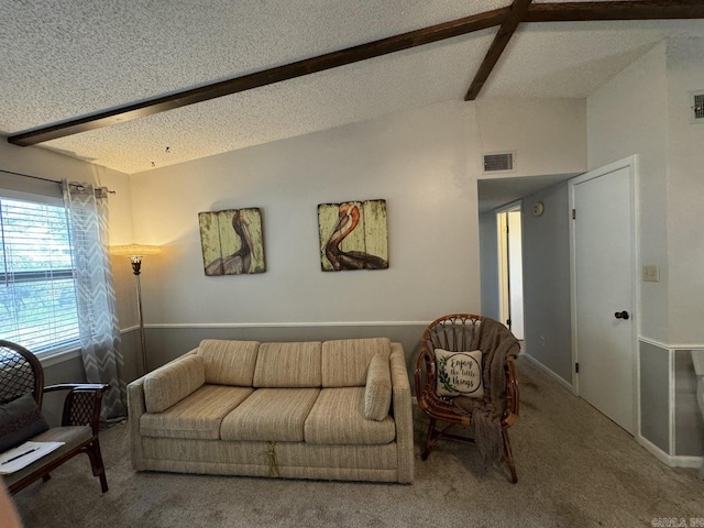 living room featuring vaulted ceiling with beams, a textured ceiling, and carpet flooring