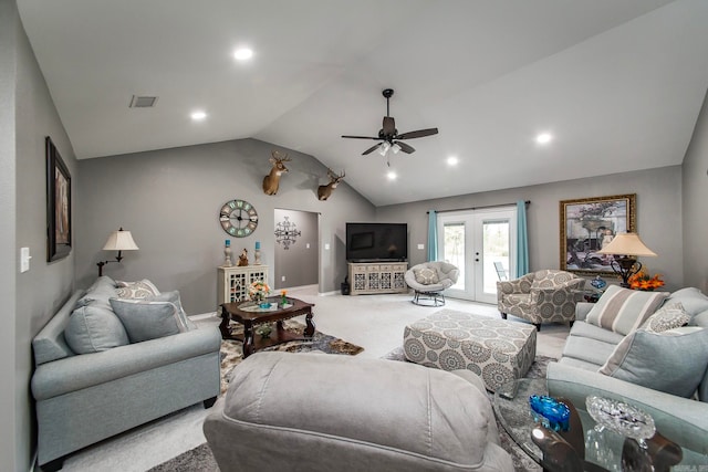 carpeted living room featuring lofted ceiling, ceiling fan, and french doors