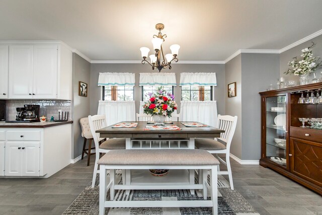 dining area with ornamental molding, hardwood / wood-style floors, and a chandelier