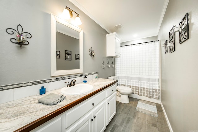 full bathroom featuring vanity, shower / bath combination with curtain, hardwood / wood-style flooring, ornamental molding, and toilet