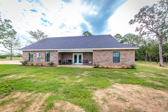 back of property featuring french doors, a yard, and a patio area