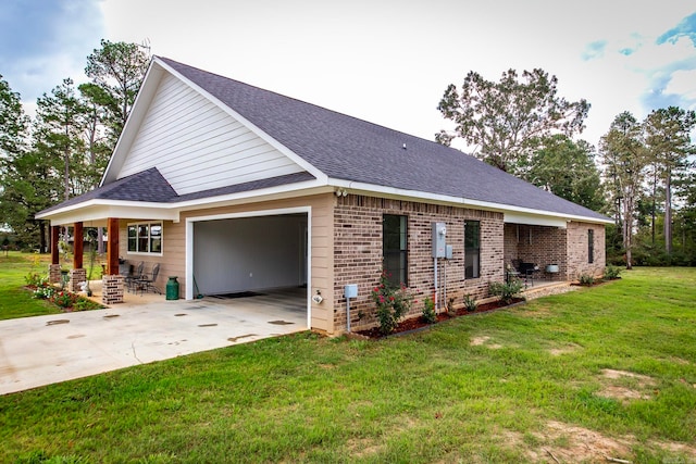 view of side of home featuring a garage and a lawn