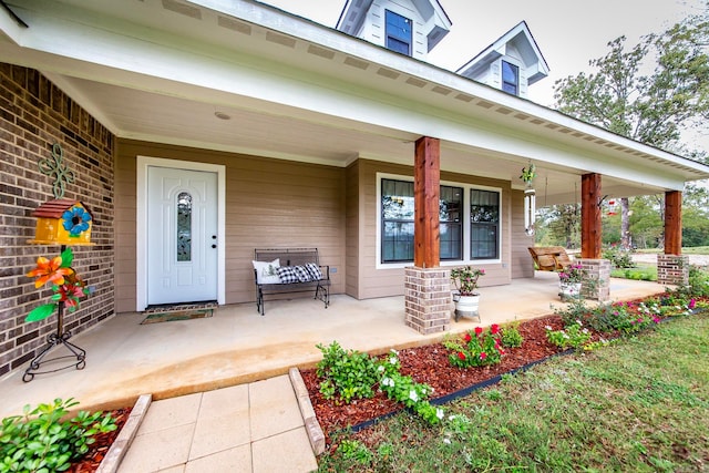 view of exterior entry featuring a porch