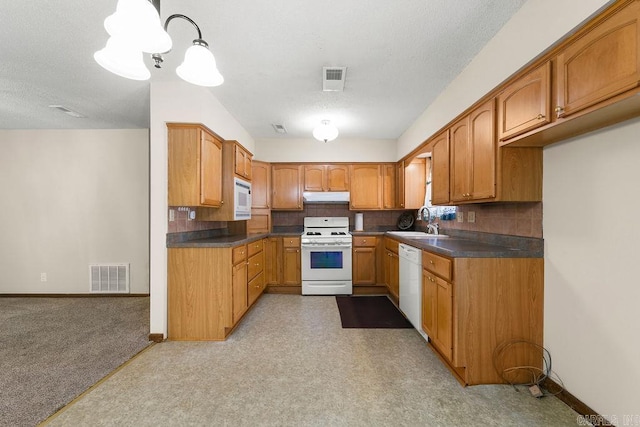 kitchen with backsplash, a textured ceiling, hanging light fixtures, and white appliances