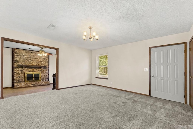 unfurnished living room featuring a brick fireplace, carpet floors, ceiling fan with notable chandelier, and a textured ceiling