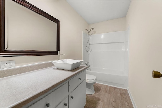 full bathroom with toilet, vanity, hardwood / wood-style floors, and  shower combination