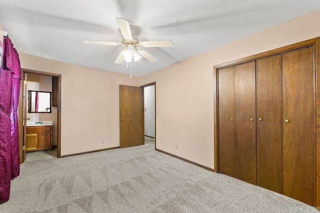 unfurnished bedroom with light carpet, a closet, ensuite bath, and ceiling fan