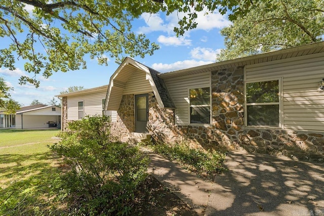 view of property exterior featuring a lawn