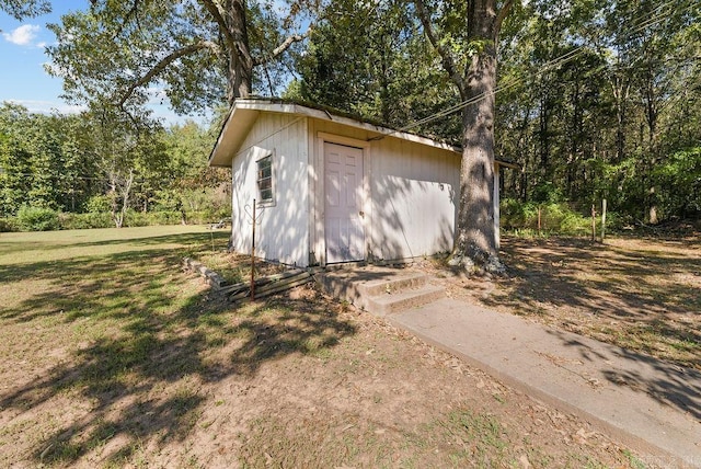 view of outbuilding with a yard