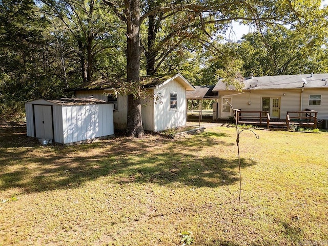 view of yard featuring a storage shed and a wooden deck