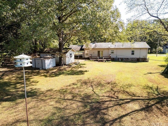 view of yard with a storage shed and a deck