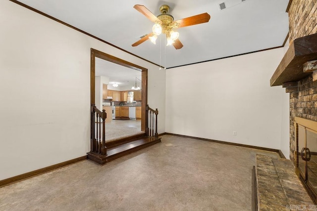 unfurnished living room with crown molding, a fireplace, carpet flooring, and ceiling fan