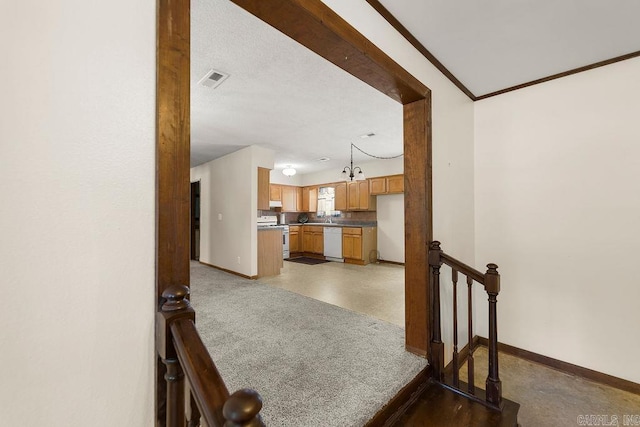 interior space featuring pendant lighting, white appliances, and crown molding