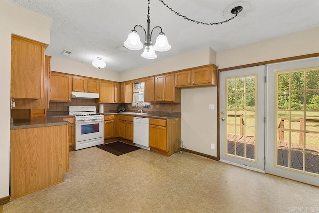 kitchen featuring pendant lighting, sink, a notable chandelier, white appliances, and backsplash