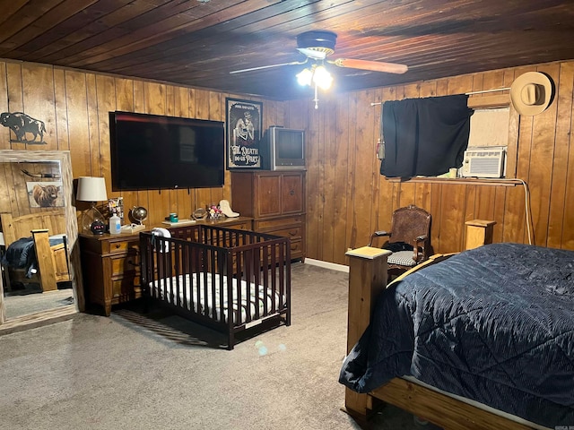 carpeted bedroom featuring wood ceiling, wood walls, and ceiling fan