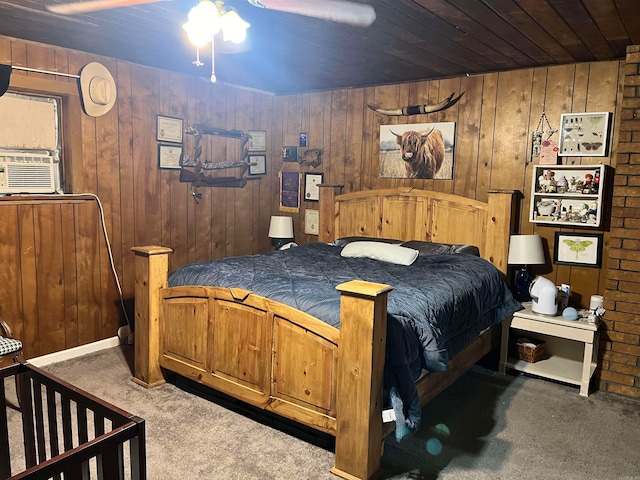 bedroom featuring light carpet, wooden walls, wood ceiling, and ceiling fan