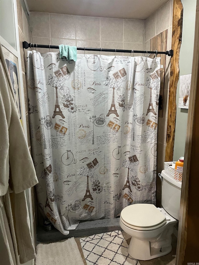 bathroom with toilet and curtained shower