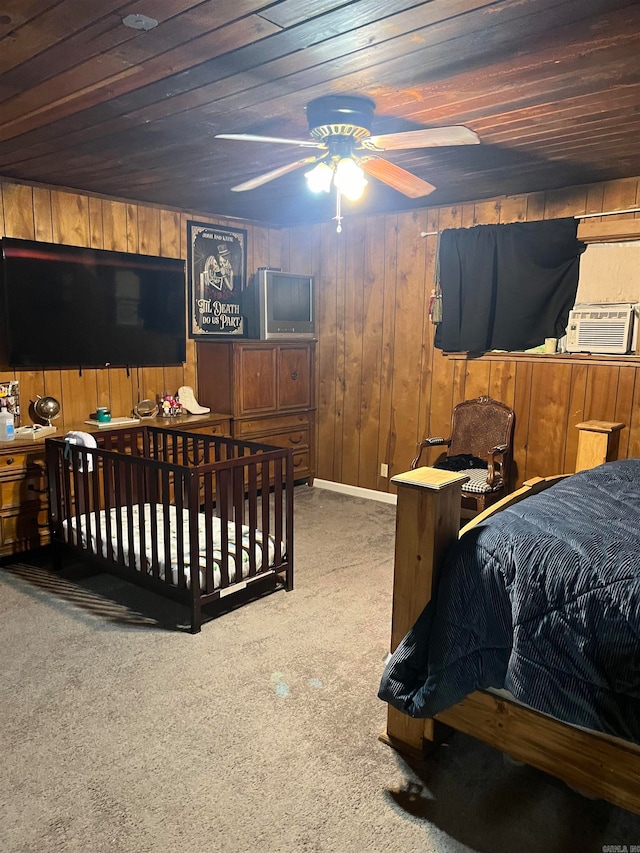 bedroom with cooling unit, wooden walls, carpet, ceiling fan, and wooden ceiling