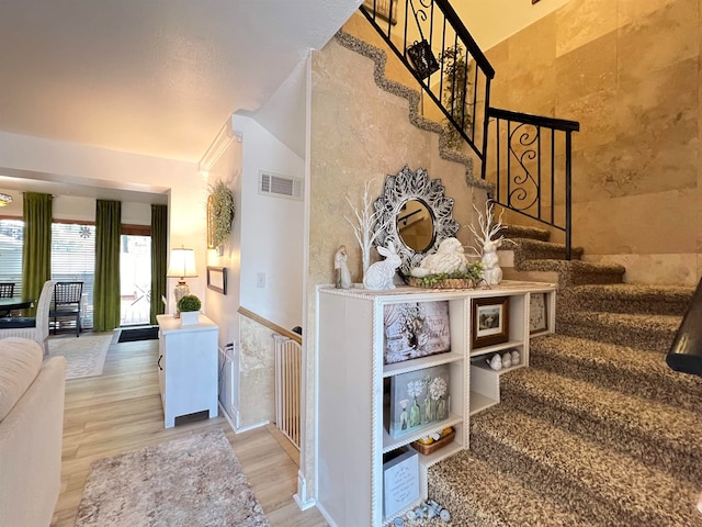 staircase with wood-type flooring