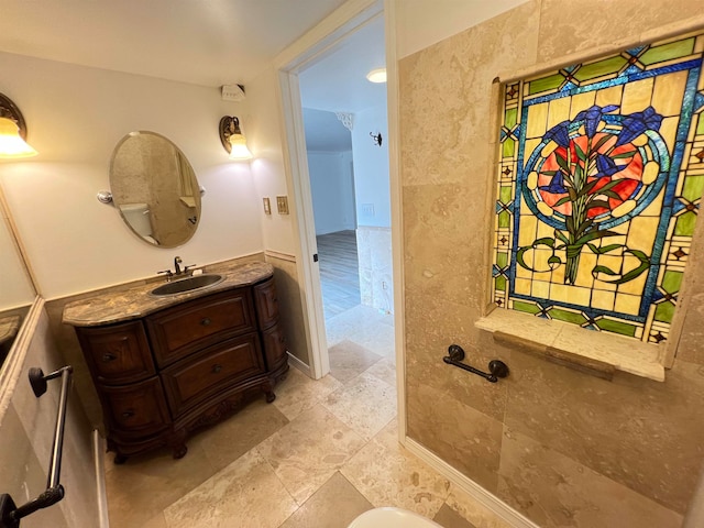 bathroom with vanity and tile walls