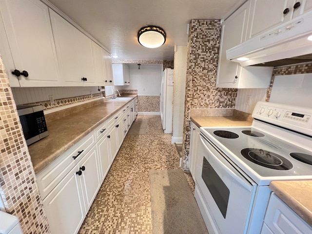 kitchen with white cabinets, backsplash, sink, and white appliances