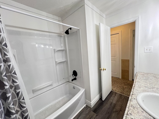 bathroom with vanity, a textured ceiling, hardwood / wood-style flooring, and shower / tub combo with curtain