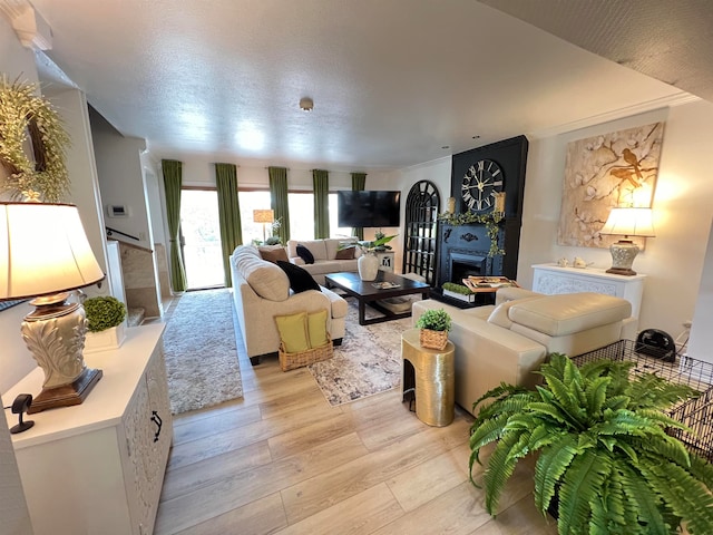 living room with a textured ceiling and light hardwood / wood-style floors