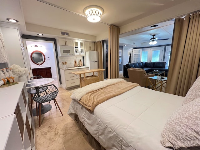 bedroom featuring stainless steel refrigerator and sink