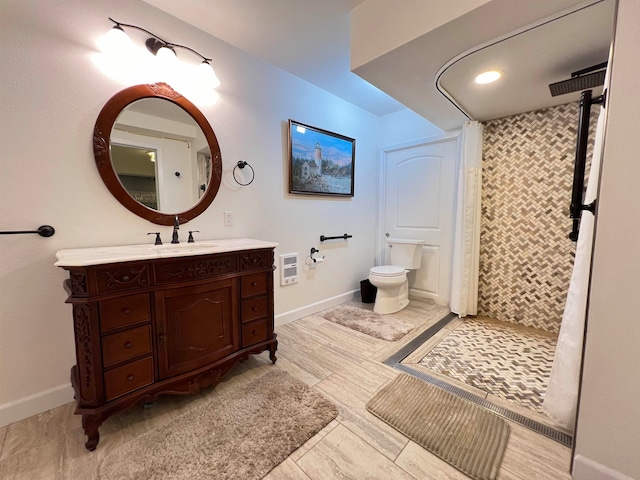 bathroom featuring vanity, tile patterned flooring, heating unit, walk in shower, and toilet