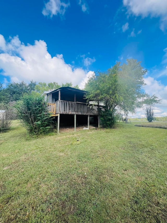 view of yard featuring a rural view and a wooden deck