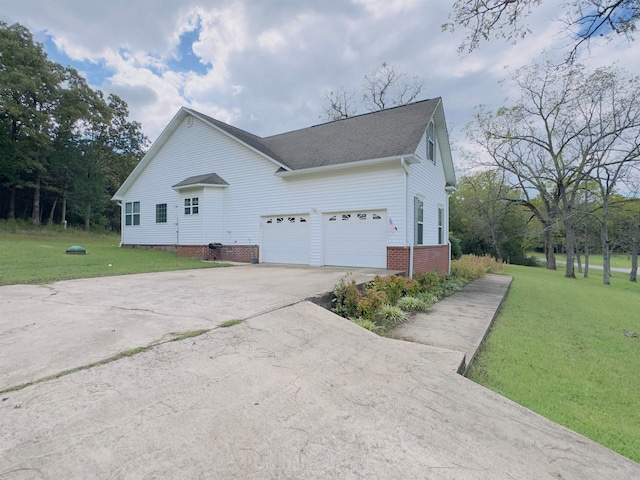 view of home's exterior with a garage and a lawn