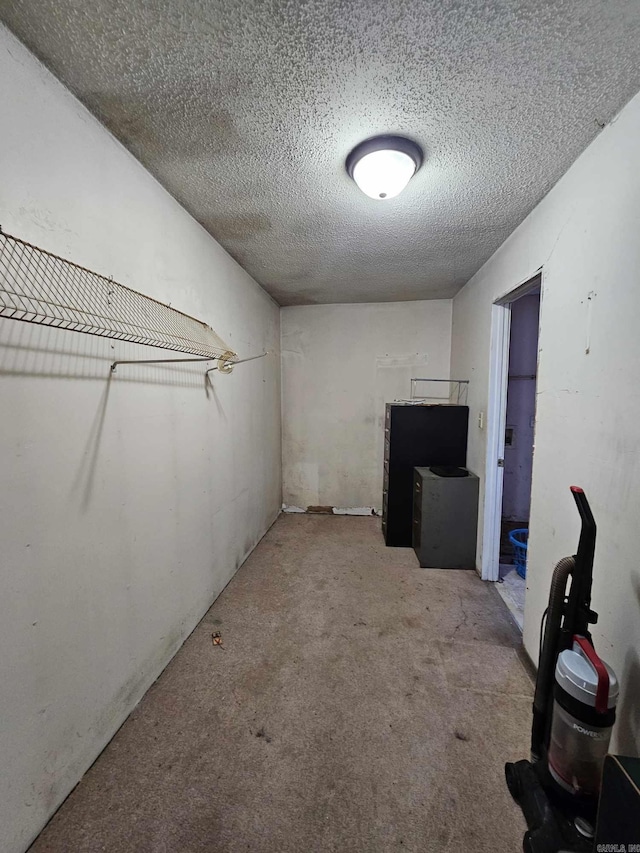 basement with a textured ceiling and light carpet