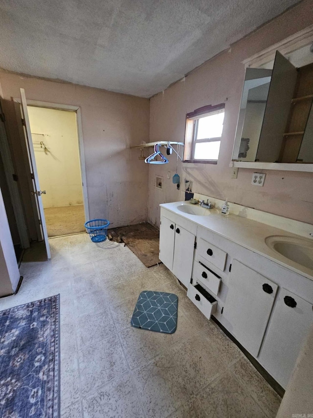 bathroom with vanity and a textured ceiling