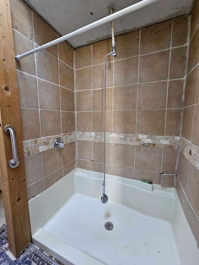 bathroom with tiled shower