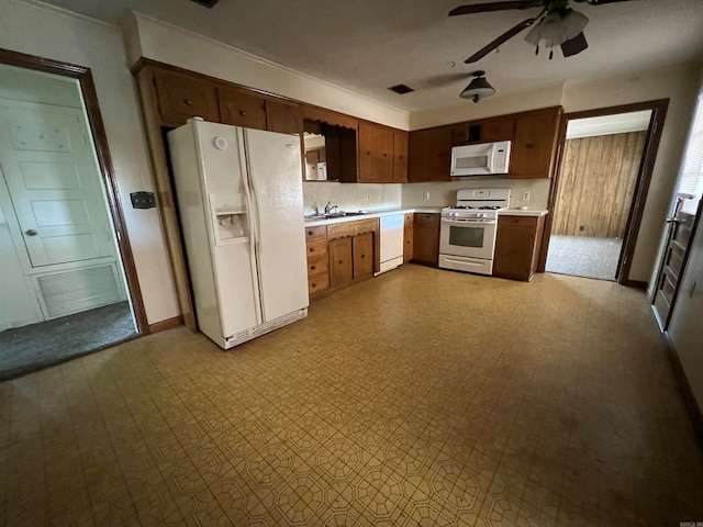 kitchen featuring white appliances, ceiling fan, and sink