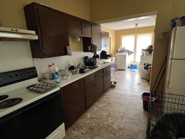 kitchen with dark brown cabinets, white appliances, and sink