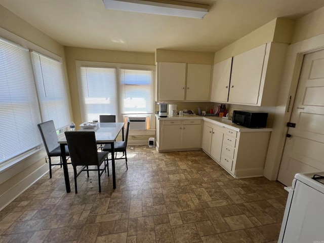 kitchen with white cabinetry and white electric range oven