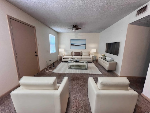 carpeted living room featuring a textured ceiling and ceiling fan