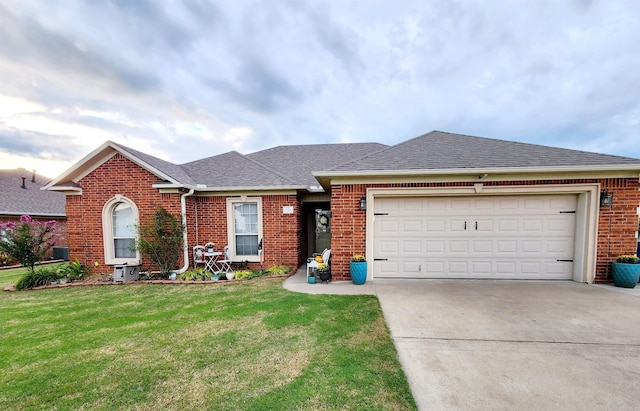 single story home featuring a front yard and a garage