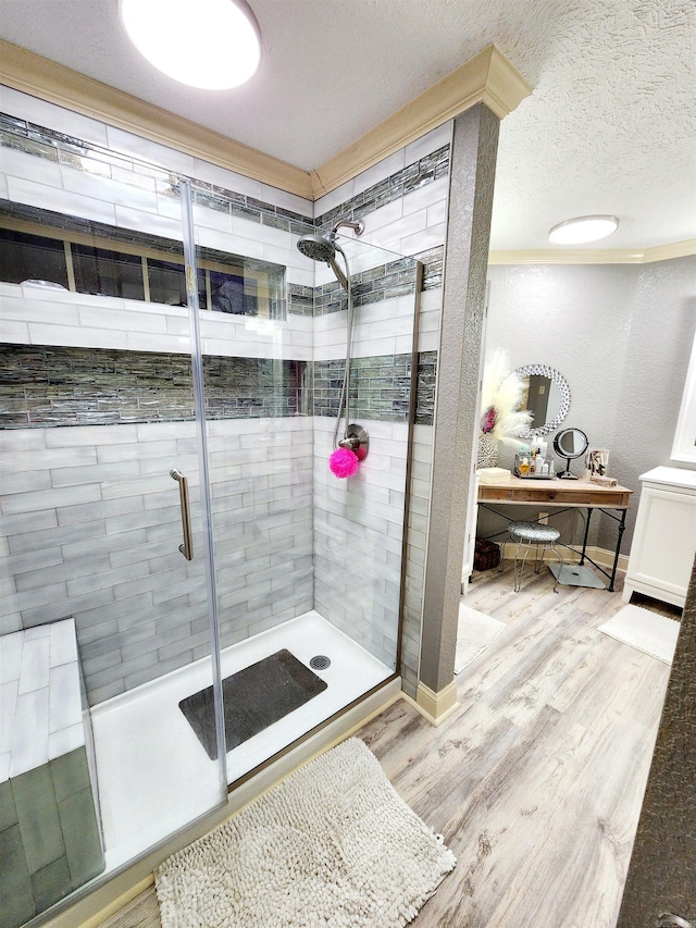 bathroom featuring wood-type flooring, a textured ceiling, and walk in shower